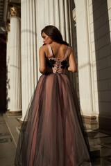 Obraz premium Young beautiful woman in an evening dress in the theater