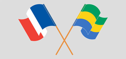 Crossed and waving flags of France and Gabon