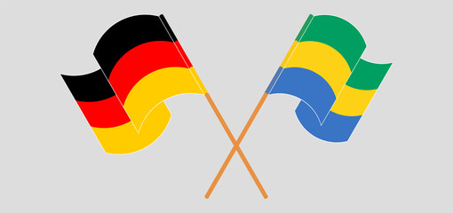 Crossed and waving flags of Germany and Gabon