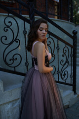 Young beautiful woman in an evening dress in the theater