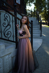 Young beautiful woman in an evening dress in the theater