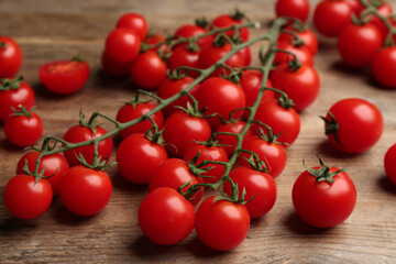 Fresh ripe cherry tomatoes on wooden table