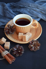 Fresh aromatic coffee in a brown Cup on a black background.