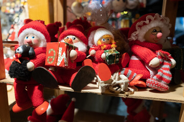 Elves on sale at Tallinn Christmas market at night. Christmas elf decoration. Handmade souvenirs or gifts. Northern Europe holiday traditions.