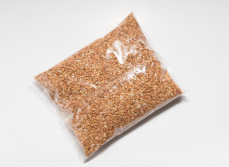 buckwheat groats in a transparent close-up bag on a white background