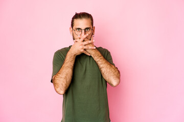 Young man with long hair look thoughtful looking to a copy space covering mouth with hand.