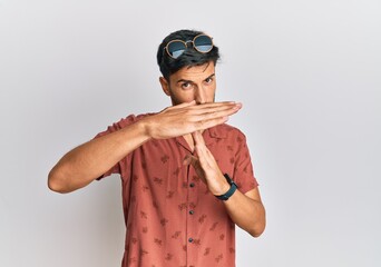 Young handsome man wearing casual summer clothes doing time out gesture with hands, frustrated and...