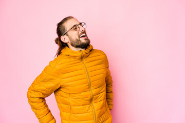 Obraz premium Young man with long hair look relaxed and happy laughing, neck stretched showing teeth.