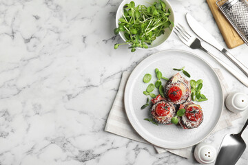 Baked eggplant with tomatoes, cheese and basil served on white marble table, flat lay. Space for text