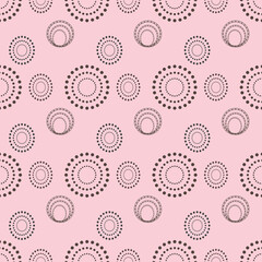 large and small circles on a pink background