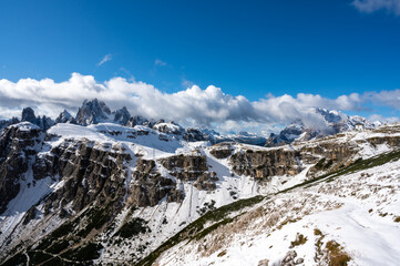 Mountain landscape with snow-capped peaks, the first snow on the peaks of the dolomites in autumn, the mountains turn white.