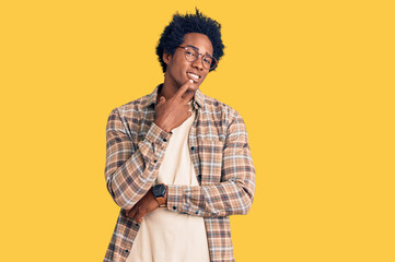 Handsome african american man with afro hair wearing casual clothes and glasses looking confident...