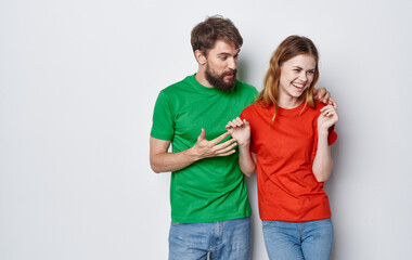 young cheerful couple in multicolored t-shirts communication emotions friendship studio