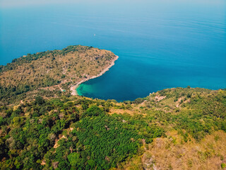 Fototapeta na wymiar Bird's eye view of tropical isolated island with beautiful coast, blue aqua sea and many trees background