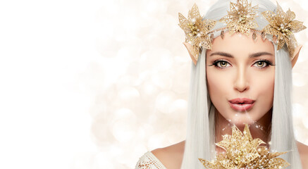 Attractive Elf Queen with Golden Christmas Poinsettia Flower in Glitters. Fairy Concept for Xmas