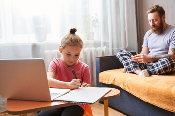 Kid preparing her lessons on laptop