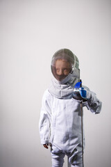 Children lunge on swords. A child in a class at a fencing school