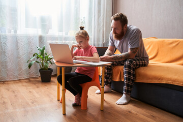 Family using a laptop for preparing lessons