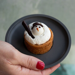 Mini cake with snowman on a little plate