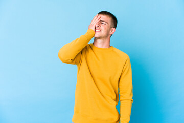 Young caucasian handsome man laughing happy, carefree, natural emotion.