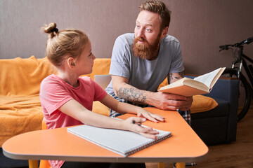 Father and small daughter looking at each other