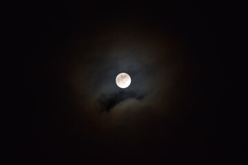 Full moon  in the clouds before eclipse