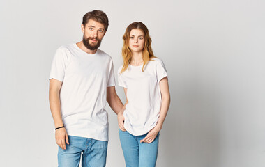 A man and a woman in jeans and a T-shirt are gesturing with their hands fun emotions Copy Space