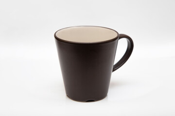 Black ceramic mug on a white background. Black glass with shadow.
