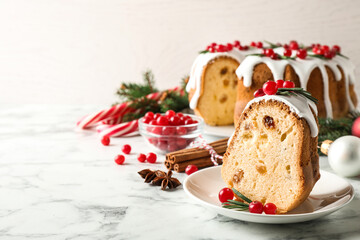 Composition with piece of traditional homemade Christmas cake on white marble table, closeup. Space for text