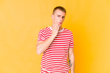 Young caucasian handsome man having a strong teeth pain, molar ache.