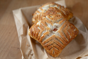 Fresh baked apple turnover on a paper bag