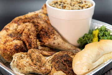 Fresh off the grill whole roasted chicken with large side of mashed potatoes and bread to feed your whole family