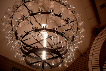 A chandelier with glasses, decor in a bar or restaurant. Restaurant business