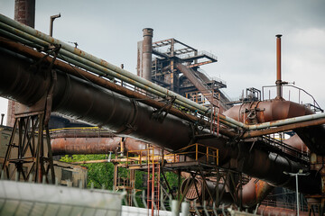 Fototapeta premium Old rusty mechanism of pipeline, former ironworks, revamped industrial park, Closed metallurgical plant, Dolni oblast Vitkovice (The Lower Vitkovice area), Ostrava, Czech Republic