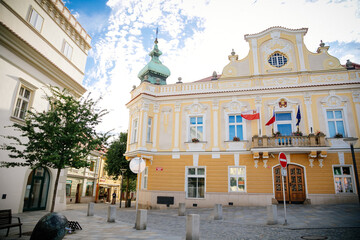 Neo-baroque yellow building of new town hall, balcony with flags, main town square, Havlickuv Brod,...