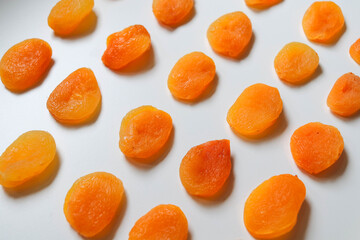 Dry apricots placed on a white board. Place for text 