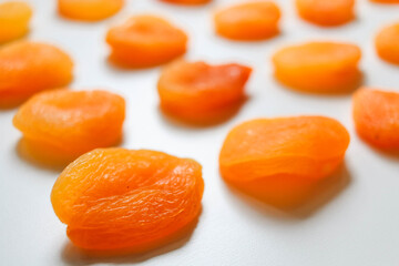 Dry apricots placed on a white board. Place for text 