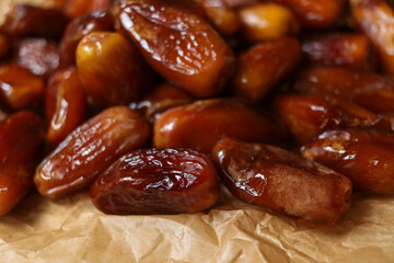 Close up of date fruits placed on brown paper