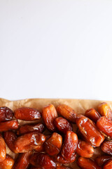 Date fruits placed on a brown paper with place for a text