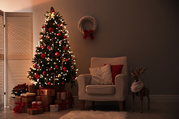 Beautiful decorated Christmas tree in living room. Festive interior