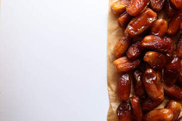 Date fruits placed on a brown paper with place for a text