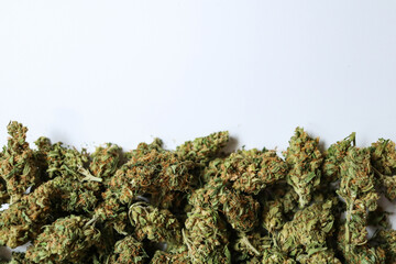 Medical marijuana flower buds placed on a white