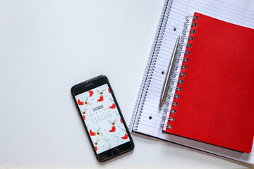 red notebook and pen