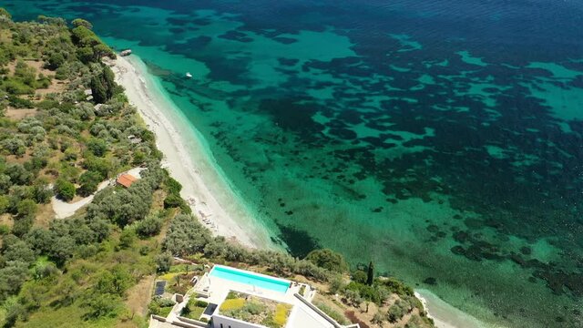 Aerial drone video of not so famous turquoise paradise beach of Armenopetra covered with pine trees, Skopelos island, Sporades, Greece
