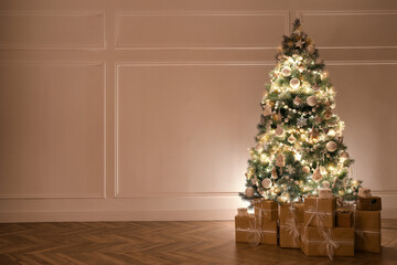 Beautiful decorated Christmas tree and gifts indoors. Space for text