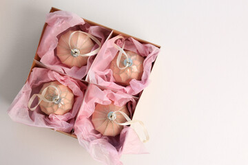 Beautiful Christmas baubles in box on white background, top view. Space for text