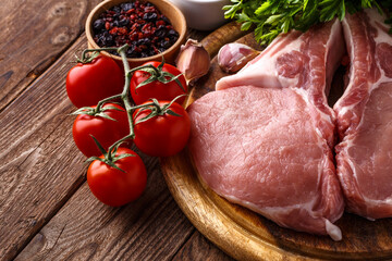 fresh raw new-york steak on wooden Board on wooden background with salt and pepper in a rustic style.