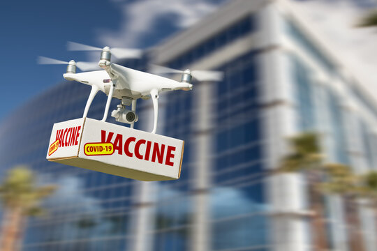 Unmanned Aircraft System (UAS) Quadcopter Drone Carrying COVID-19 Vaccine Package Near Building