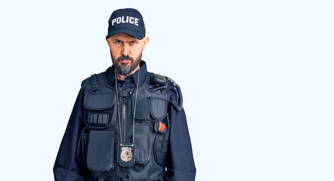 Young handsome man wearing police uniform depressed and worry for distress, crying angry and afraid. sad expression.