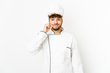 Young arab cook man with fingers on lips keeping a secret.